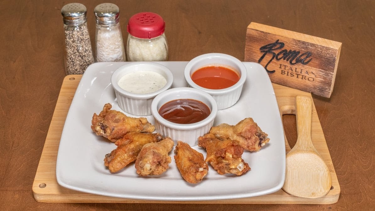 Chicken wings with ranch, buffalo, and BBQ dipping sauces