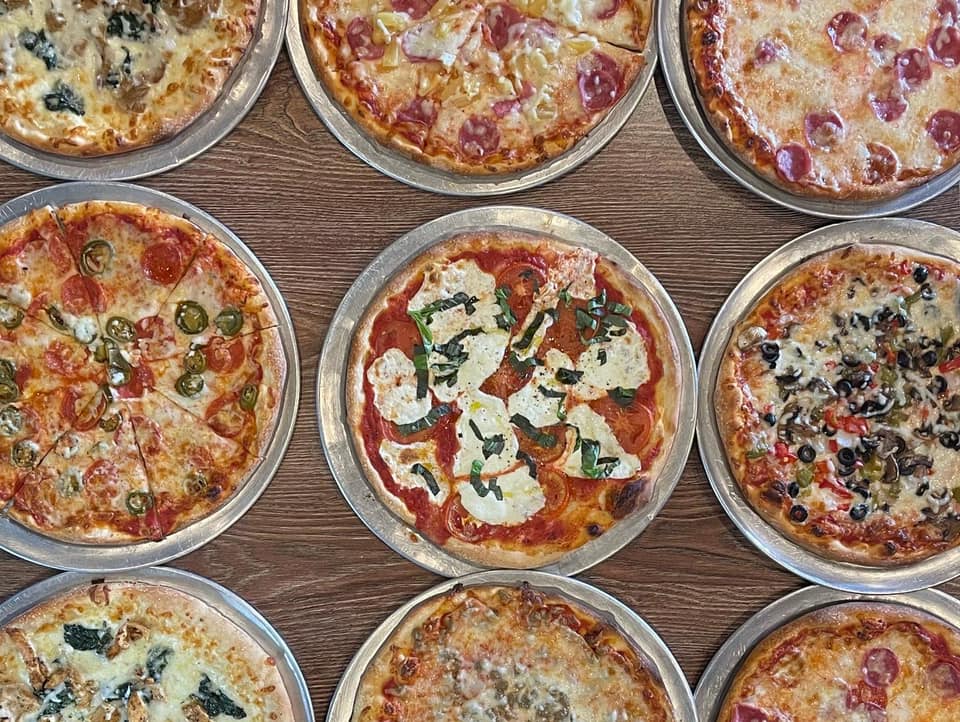 Assortment of Roma Italian Bistro pizzas including Margherita, pepperoni, jalapeño, and Supreme