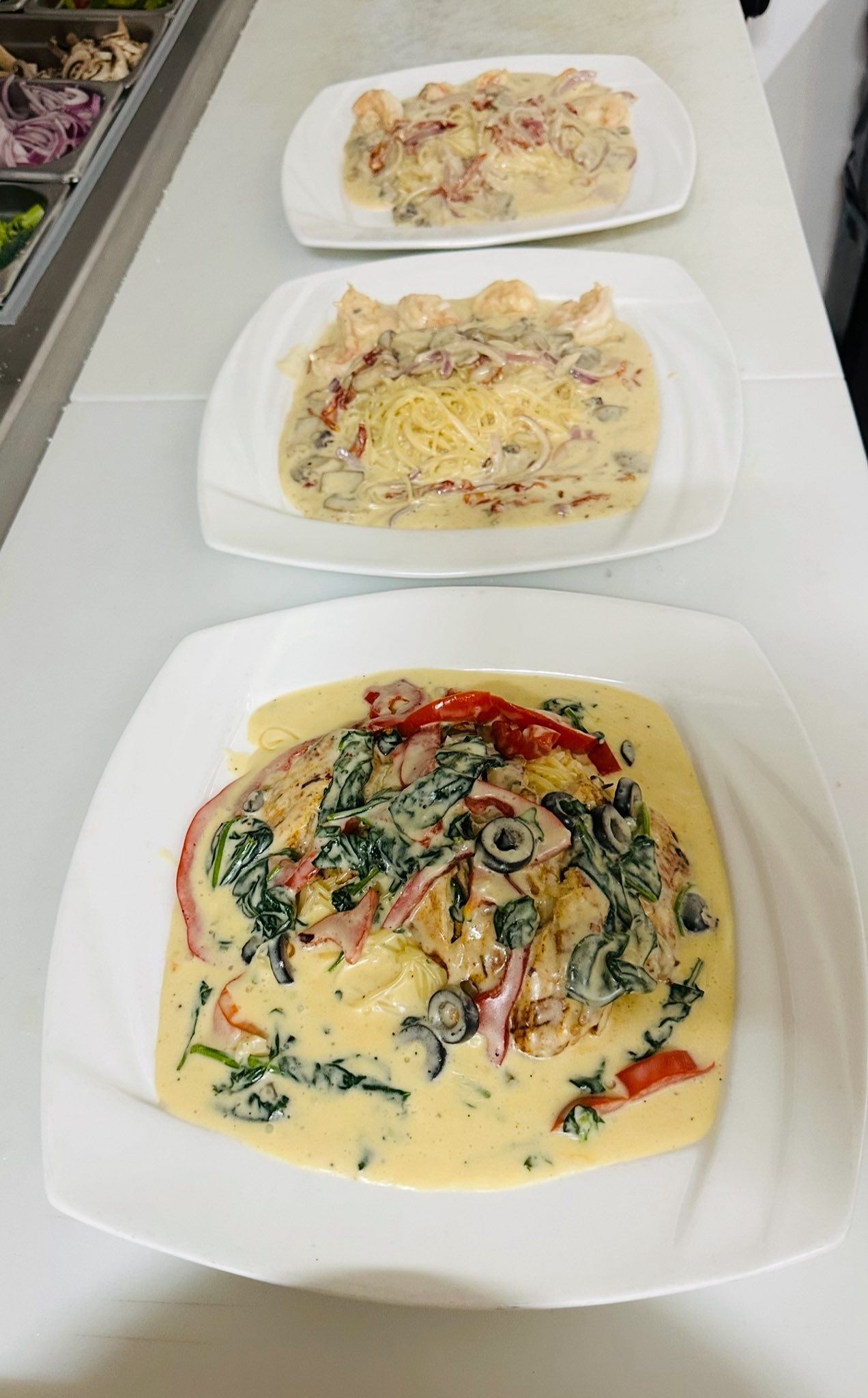 Chicken Primavera with spinach, red pepper and olives in cream sauce