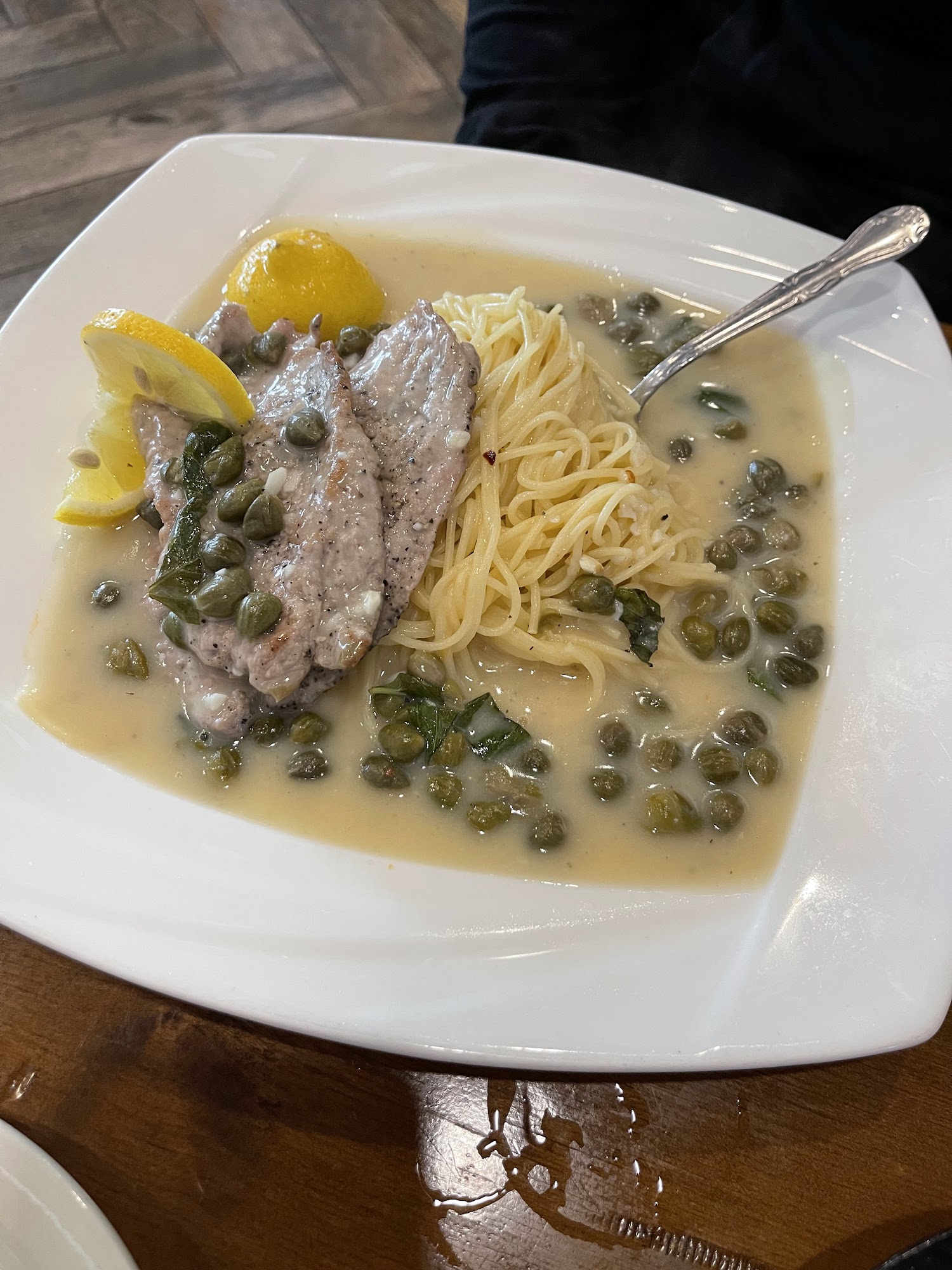 Veal Piccata with capers and lemon over angel hair pasta